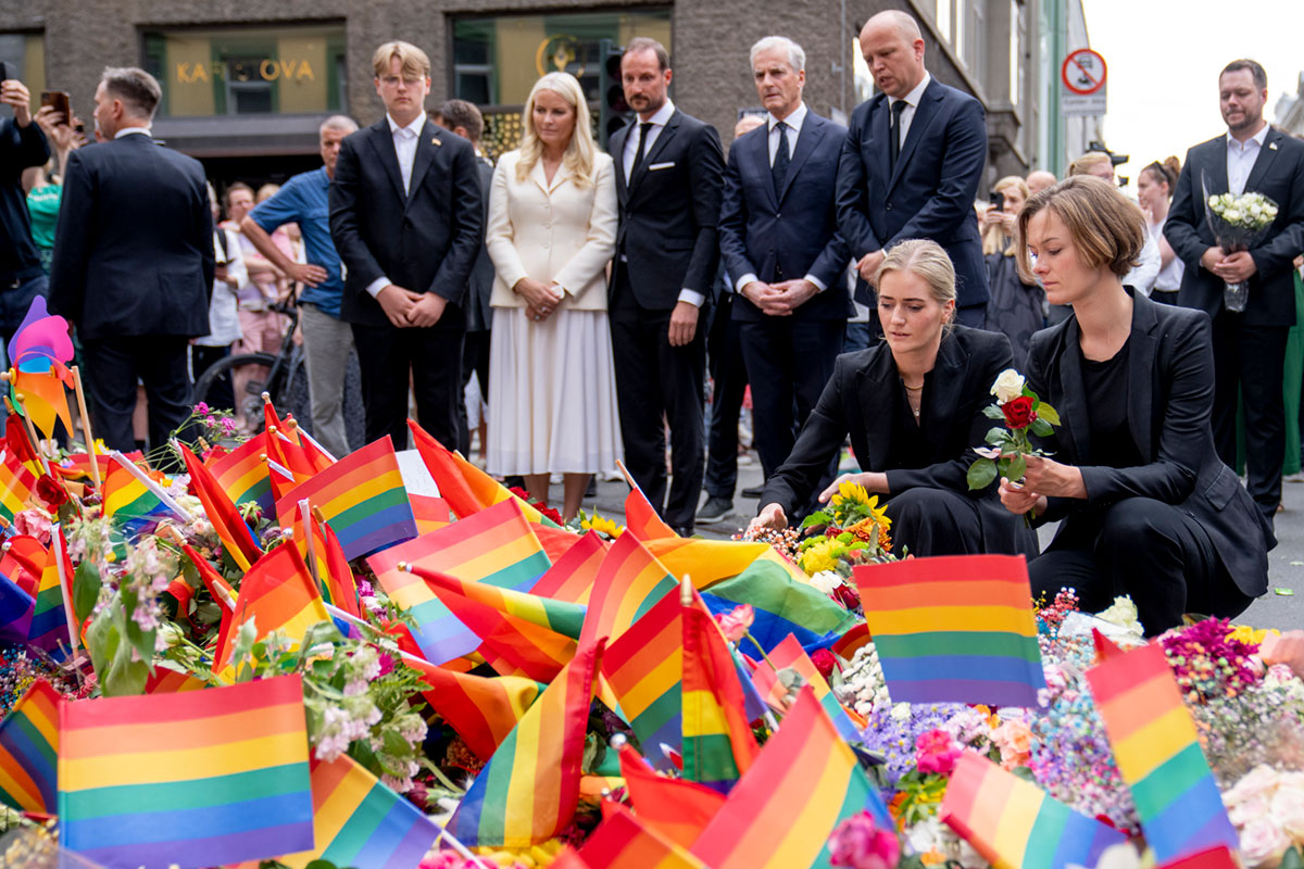 Kultur- og likestillingsminister Anette Trettebergstuen (Ap) og  justisminister Emilie Enger Mehl (Sp) legger ned blomster ved  åstedet for skyteangrepet i Oslo sentrum. Bak dem står prins  Sverre Magnus, Kronprins Haakon, kronprinsesse Mette-Marit og  statsminister Jonas Gahr Støre (Ap).