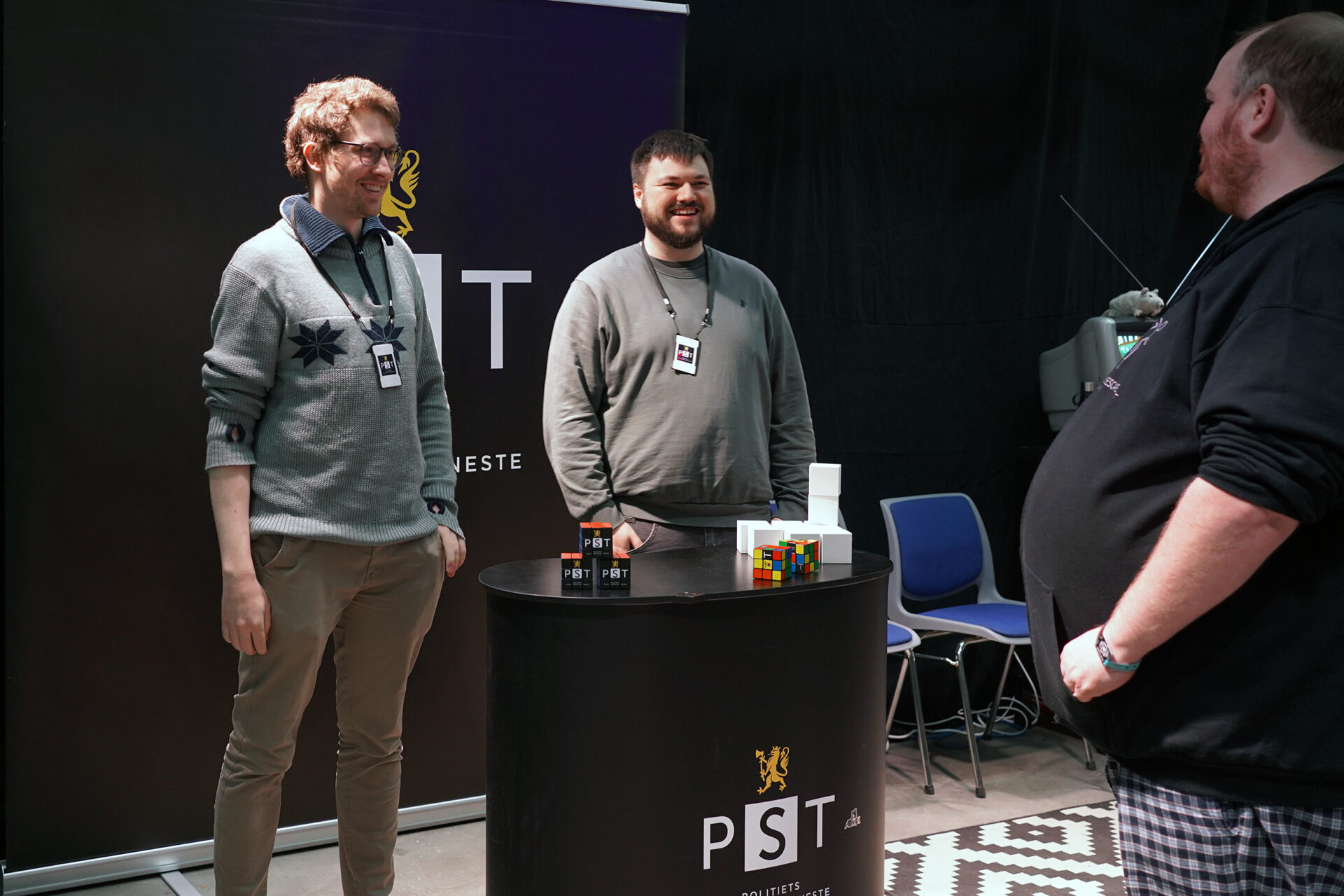 To PST-teknologer får besøk på standen. Foto.