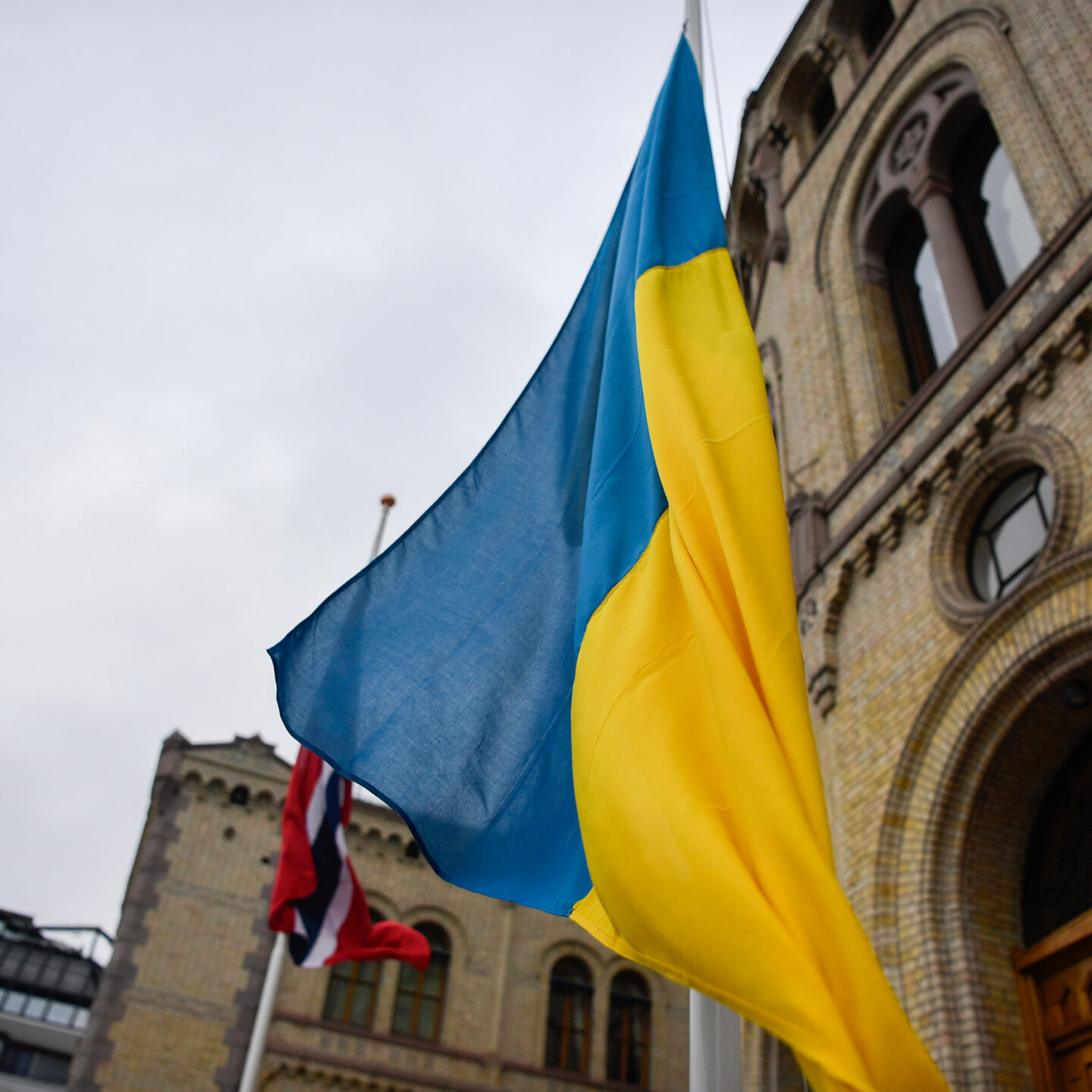 Det ukrainske flagget heises på flaggstang. Stortinget i bakgrunnen. Foto
